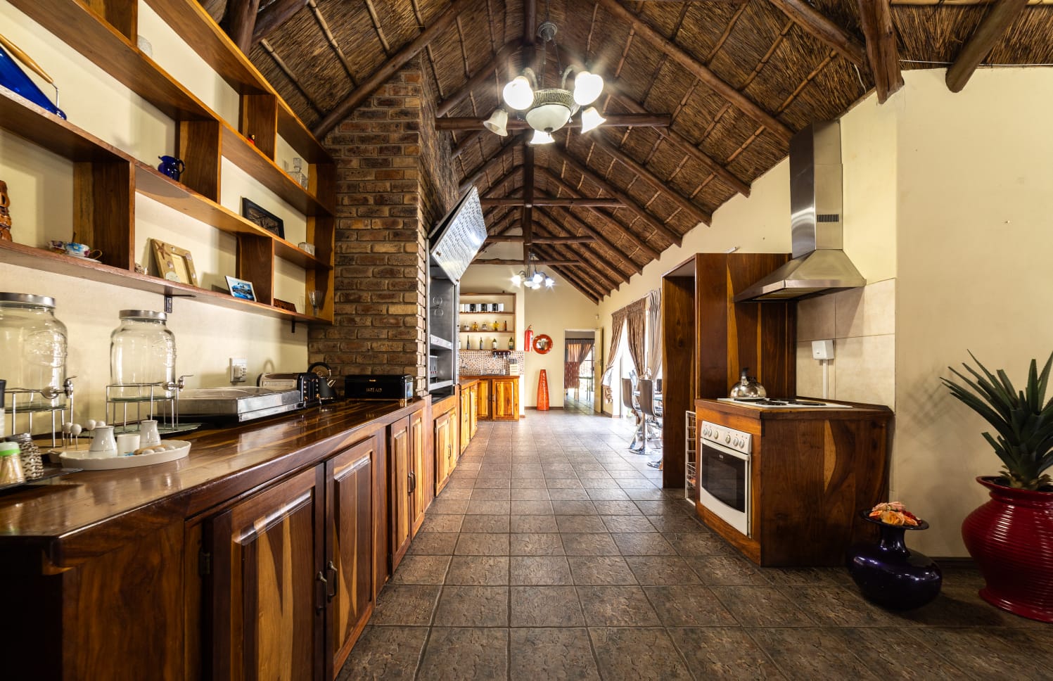 Fully equipped guest kitchen with wooden cabinetry, high ceilings, and modern appliances for a self-catering stay in Eldoraigne.