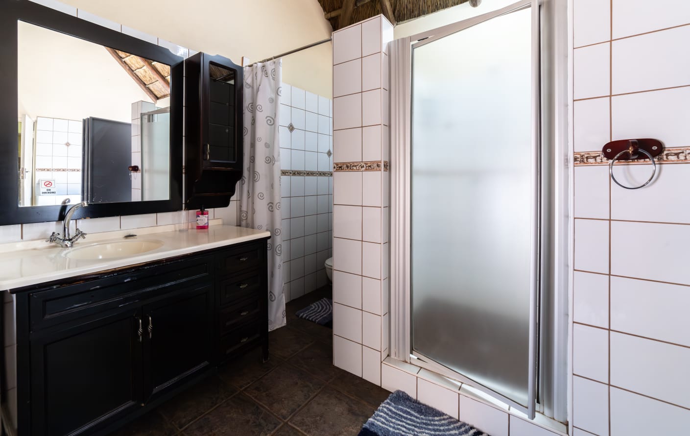 Guest room amenities including a wall-mounted TV, bar fridge, microwave, and desk for a comfortable stay.